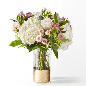 Spring soiree bouquet, A bouquet of white hydrangeas, pink roses, and green flowers in a gold vase.