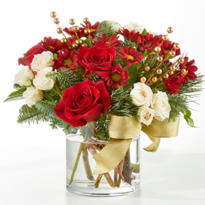 Believe Bouquet with red roses, white flowers, and a golden ribbon in a glass vase.