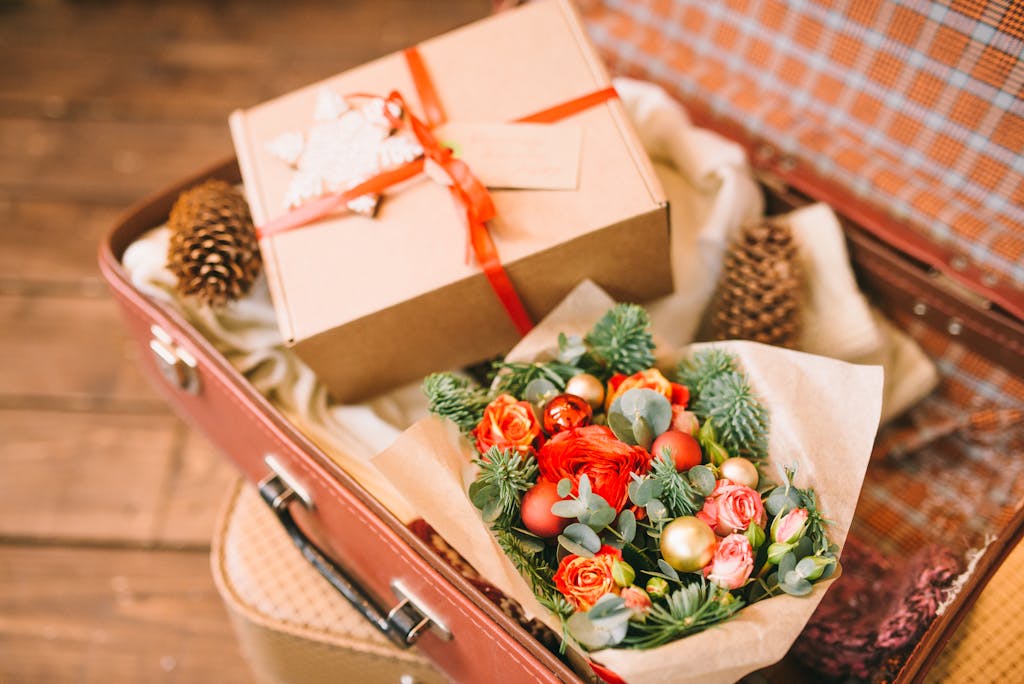 A beautifully wrapped gift box with Christmas decorations and pine cones.