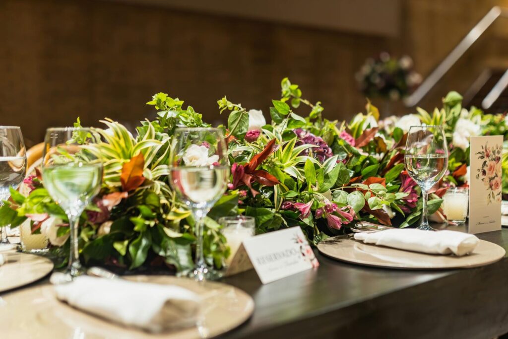 Elegantly decorated table with floral arrangements and glassware, perfect for a celebration or special event.