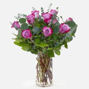 1-Dozen Deep Purple Roses | Flower Delivery in Orange County, Irvine & Lake Forest arranged with eucalyptus and lush greenery in a clear glass vase