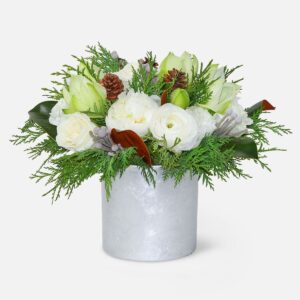 Winter-inspired white floral arrangement in a silver cylinder vase