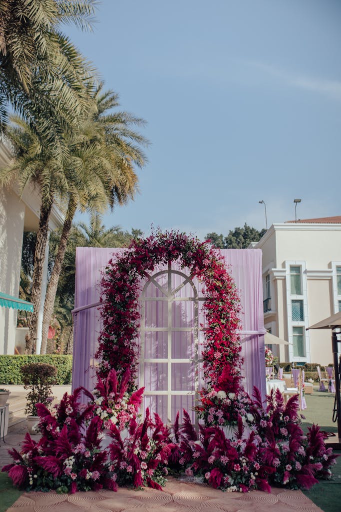 Beautiful floral arch with vibrant flowers in an outdoor garden setting.